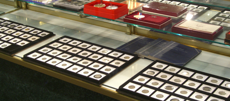 collectible coins, shop counter, medals